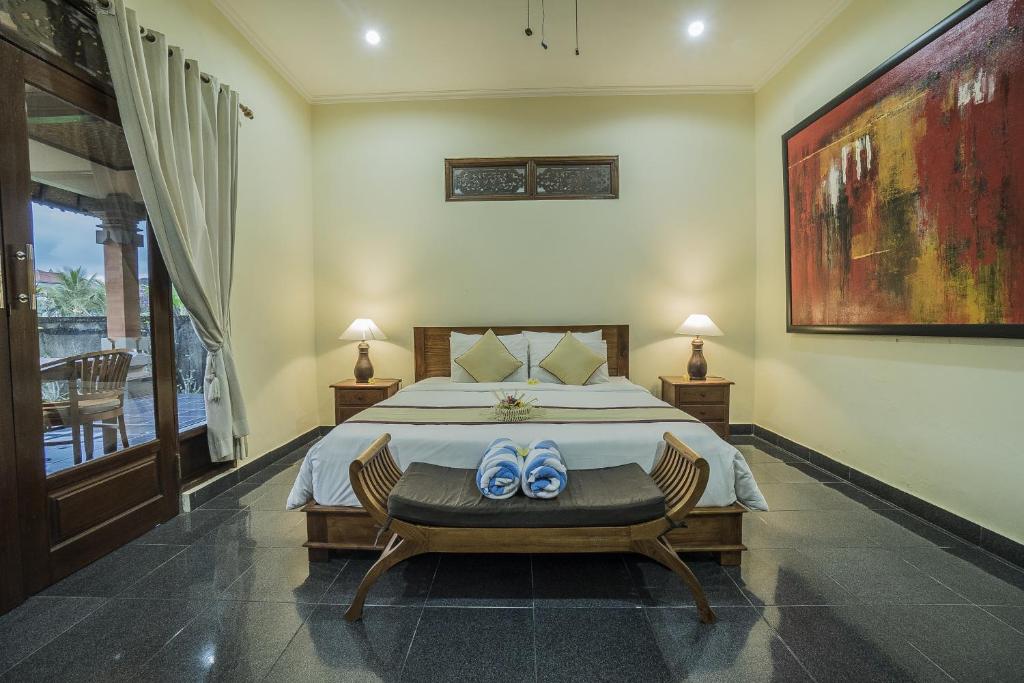 Postel nebo postele na pokoji v ubytování Nyoman Sandi Guest House