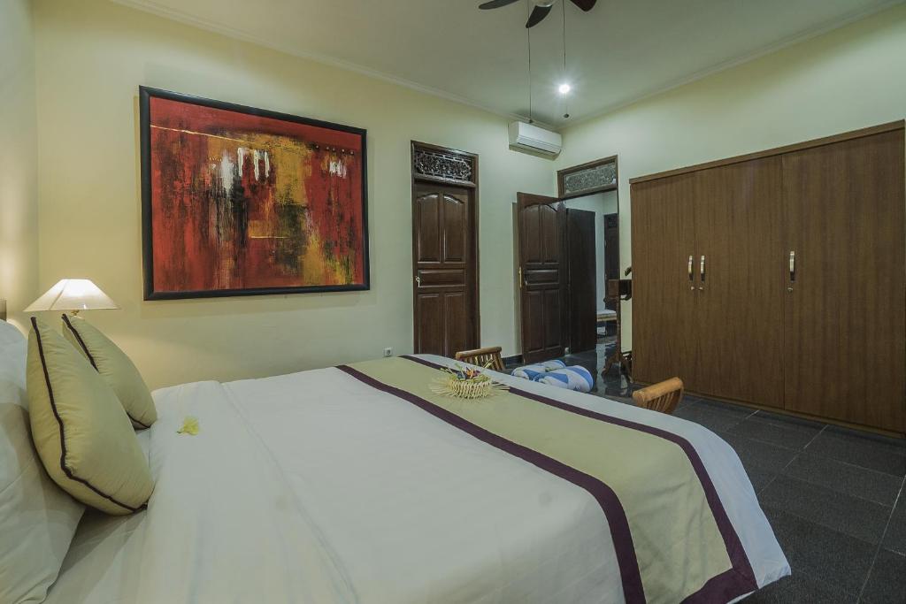 Postel nebo postele na pokoji v ubytování Nyoman Sandi Guest House