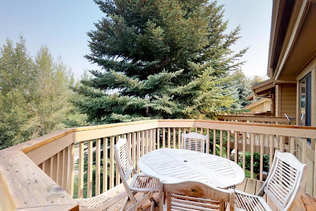 a wooden deck with a table and chairs on it at Snow Creek 1510 in Sun Valley