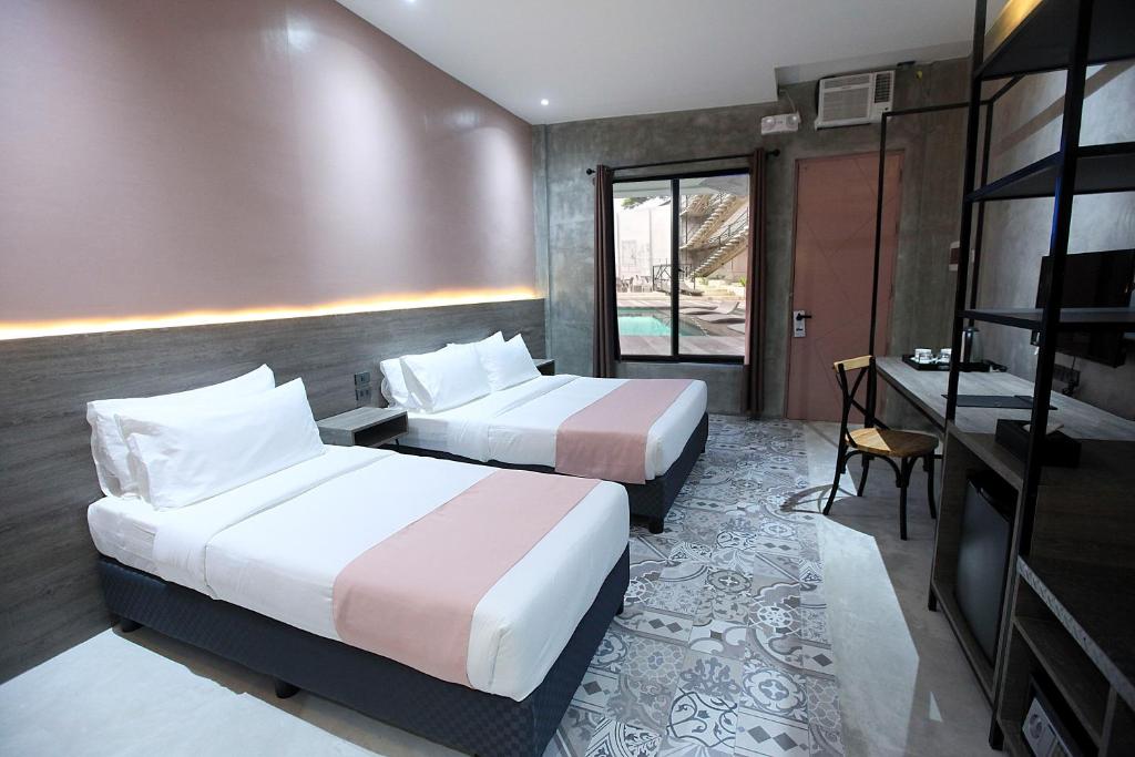 Postel nebo postele na pokoji v ubytování Zenvea Hotel