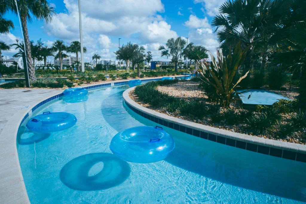 a swimming pool with blue frisbees in it at Luxury Thownhouse with private pool in Kissimmee
