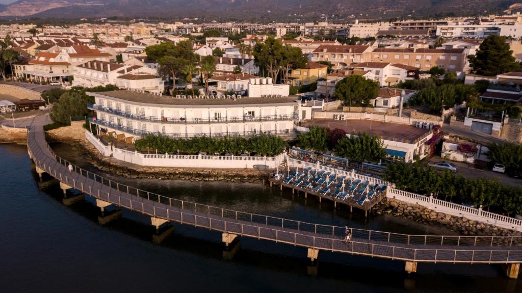 an aerial view of a building next to the water at Hotel Restaurant Juanito Platja in Sant Carles de la Ràpita