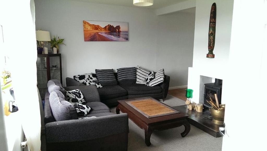 a living room with a couch and a coffee table at Nice double and single rooms in the quiet area with excellent shared facilities in Plymouth