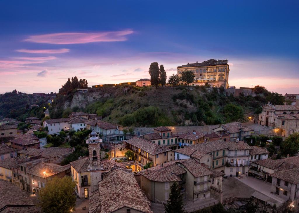 a view of a town with a castle on a hill at Il Cortile di San Michele in Guarene