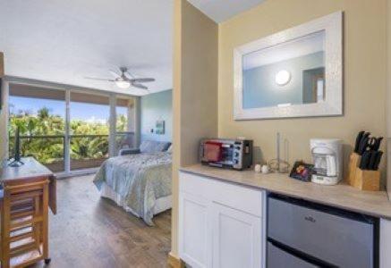 a room with a bedroom with a bed and a window at Maui Banyan G203a in Wailea