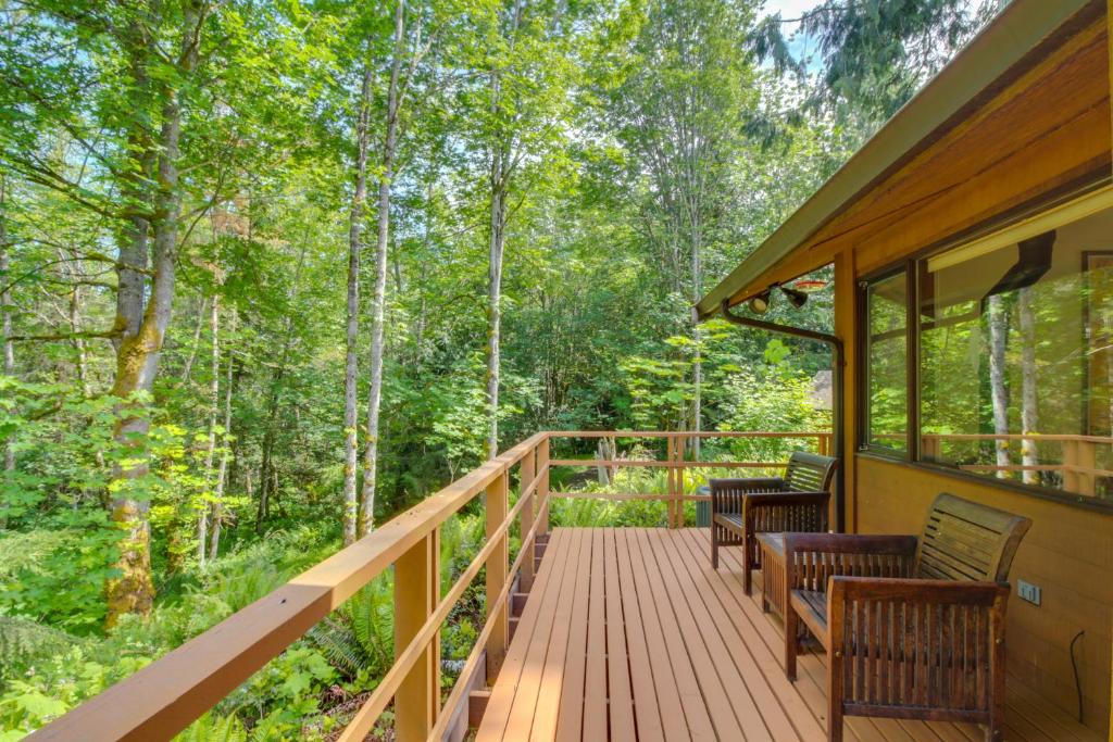 a wrap around deck on a cabin in the woods at Sleeping Raven Woodland Retreat in Port Angeles
