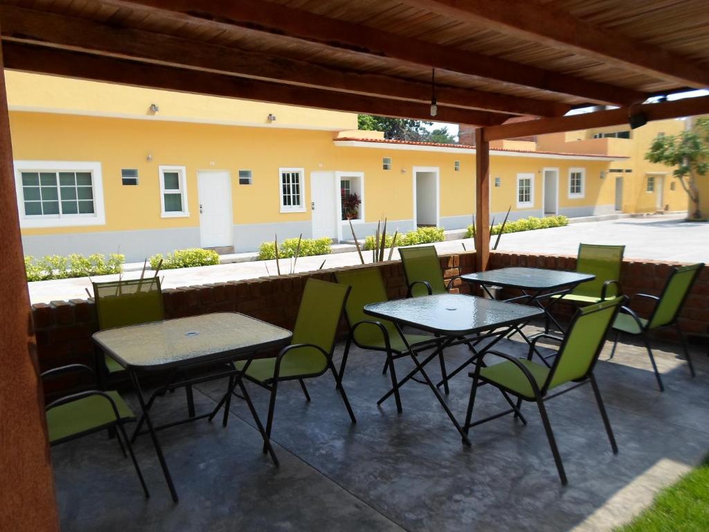 a group of tables and chairs on a patio at Hotel Montroi City in Colima