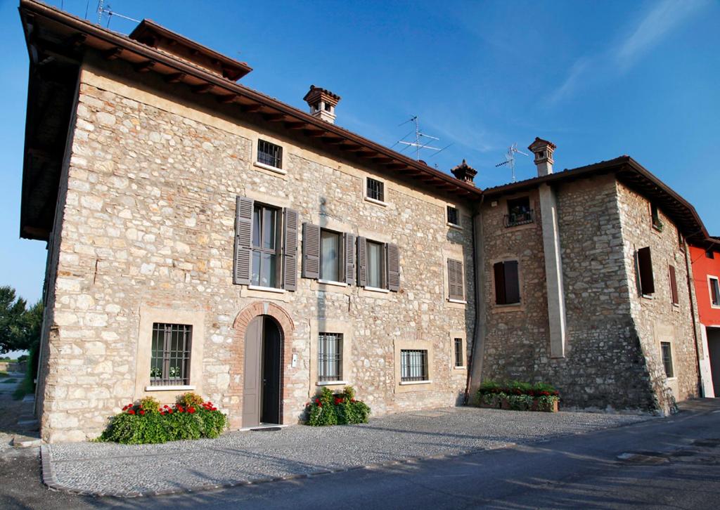 a large brick building with two windows and a door at B&B Camignone Franciacorta in Passirano