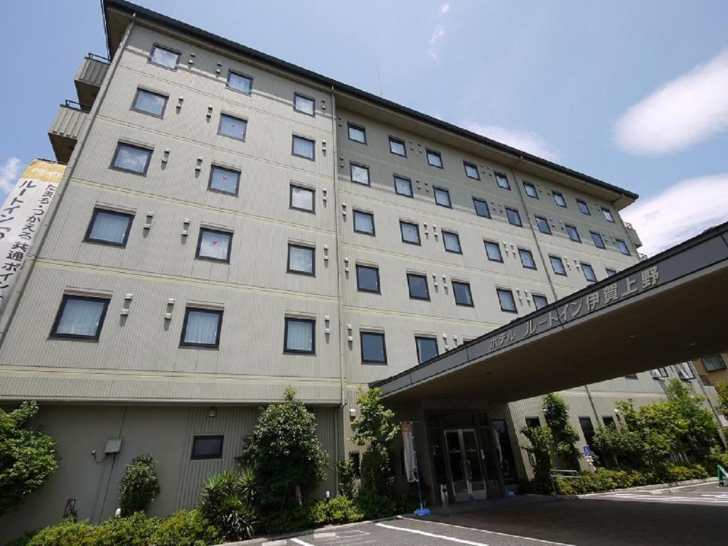 a large white building with a lot of windows at Hotel Route-Inn Igaueno -Igaichinomiya Inter- in Iga