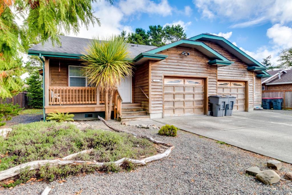a wooden house with a garage at Edgewood Getaway in Seaside