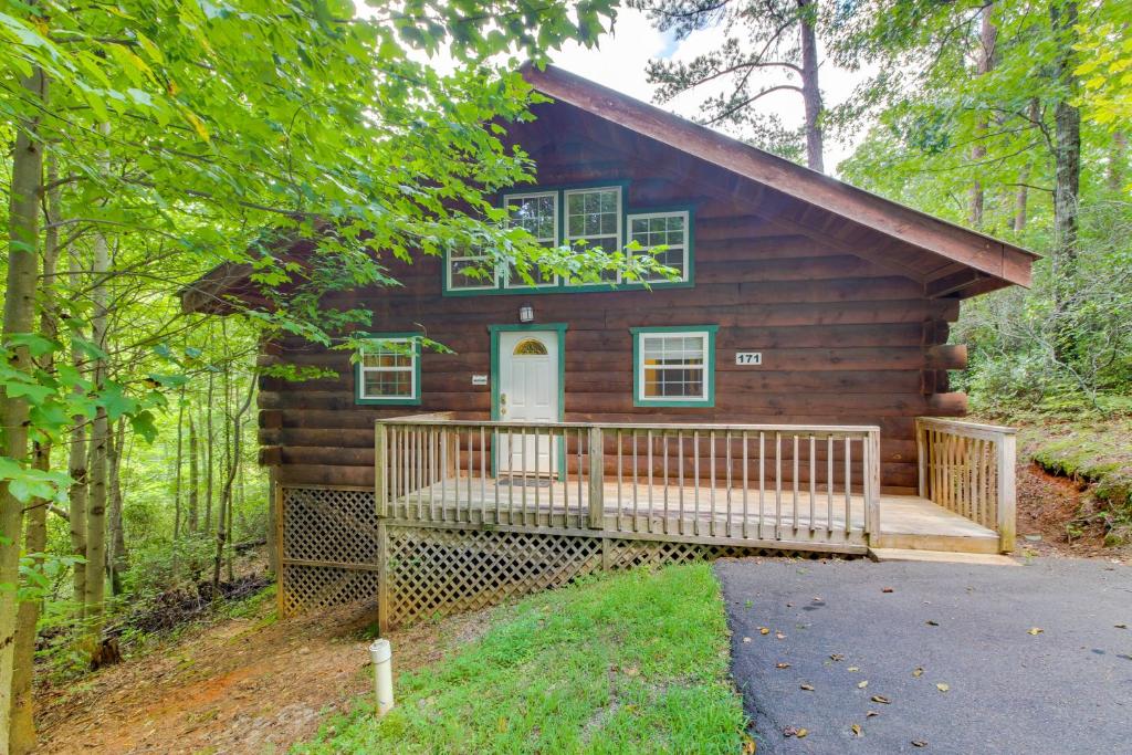 a log cabin in the woods with a porch at Angler's Haven in Sautee Nacoochee