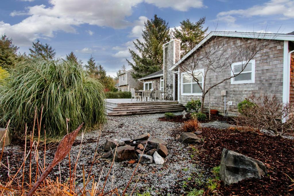 a home with a gravel yard in front of a house at Beach Stroll Haven in Gearhart