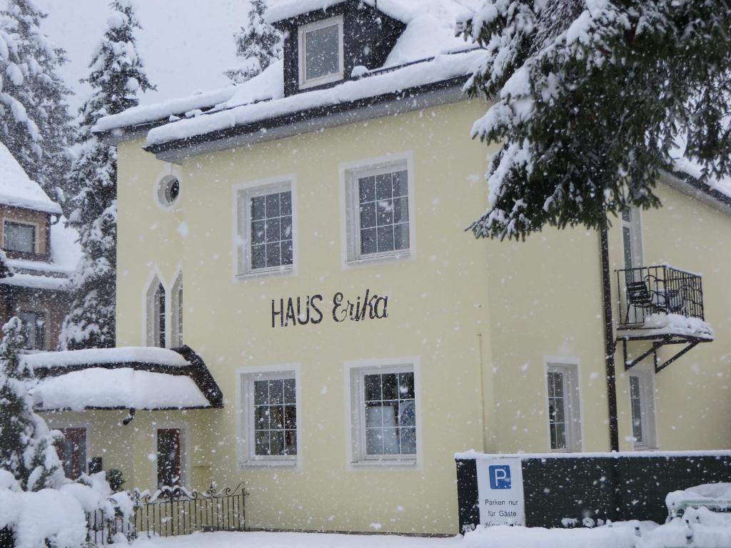 
a snow covered building with a sign on the front of it at Haus Erika Bad Gastein B & B in Bad Gastein
