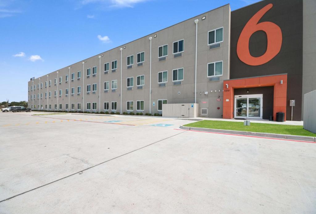 a large building with a large number on it at Studio 6-Corpus Christi, TX in Corpus Christi