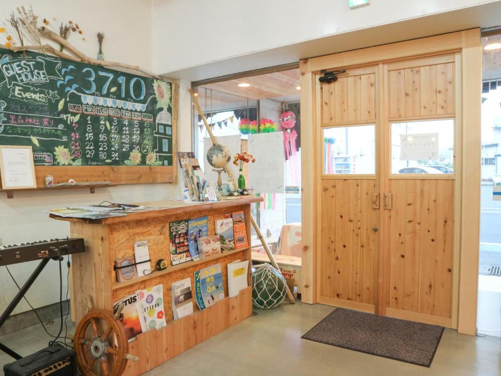 a classroom with a chalkboard next to a door at Guest House Minato in Miyako
