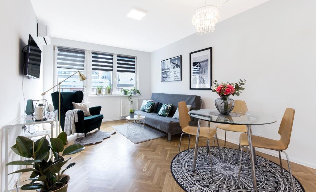 a living room filled with furniture and a window at Warsawrent Apartamenty Centralna in Warsaw