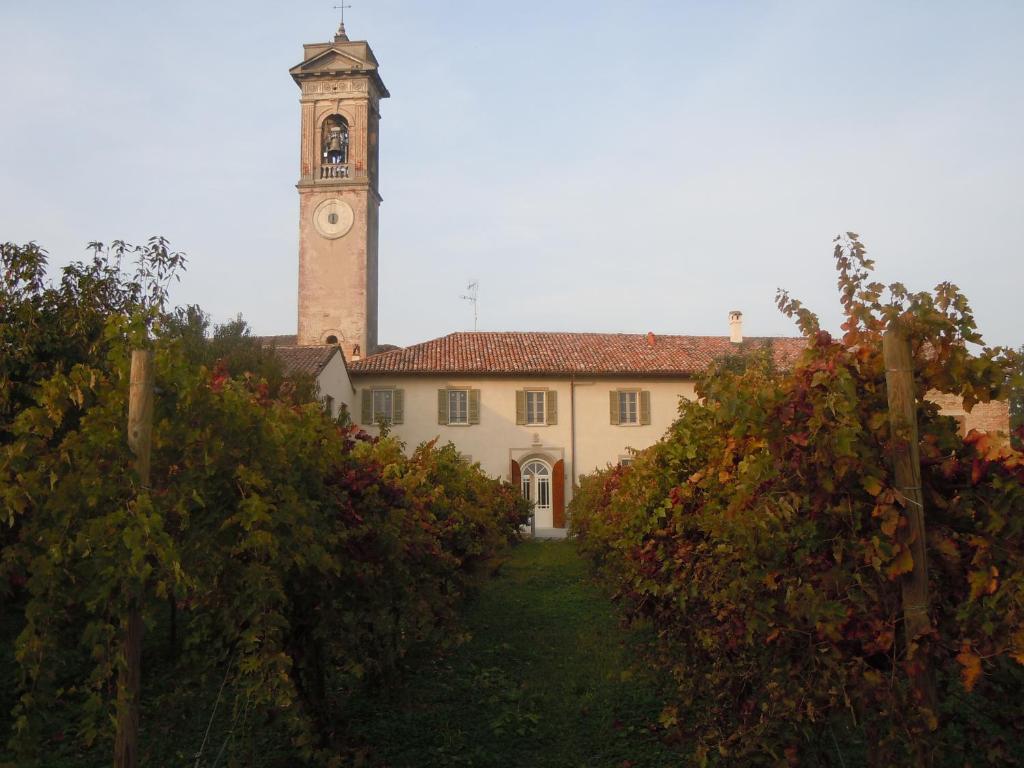un edificio con una torre de reloj encima en Ostello La Canonica, en Motta Baluffi