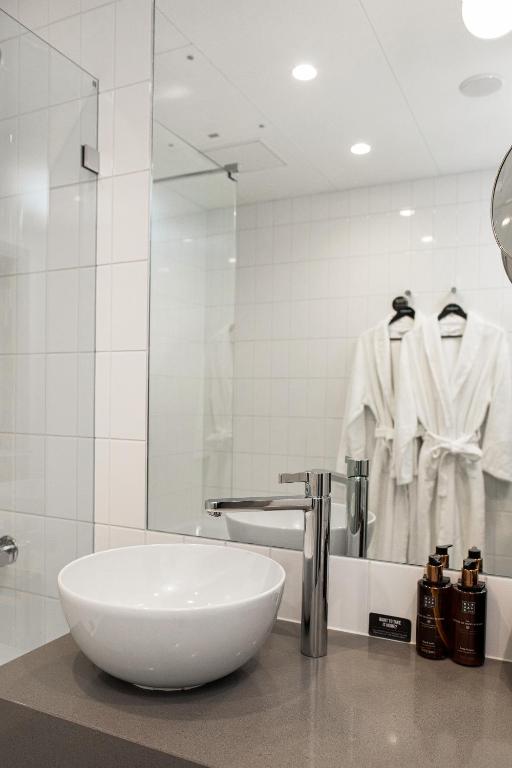 a bathroom with a white sink and a mirror at Clarion Hotel Oslo in Oslo