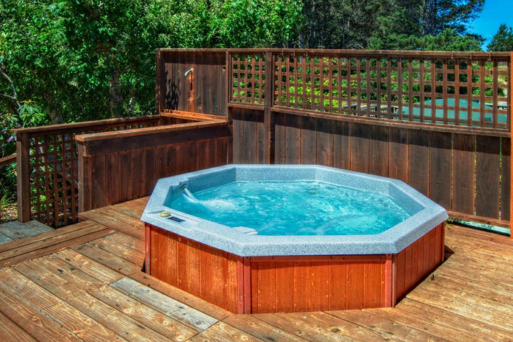 a hot tub on a deck with a wooden fence at Mendocino Dream in Mendocino