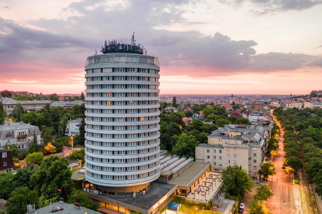 a tall building in a city at sunset at Hotel Budapest in Budapest