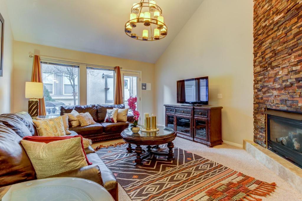 a living room with a couch and a fireplace at Oaks at Wasatch #5 in Cottonwood Heights