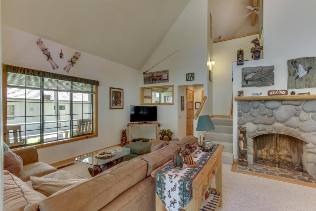 a living room with a couch and a fireplace at Circle 4 Ranch 31 | Discover Sunriver in Sunriver