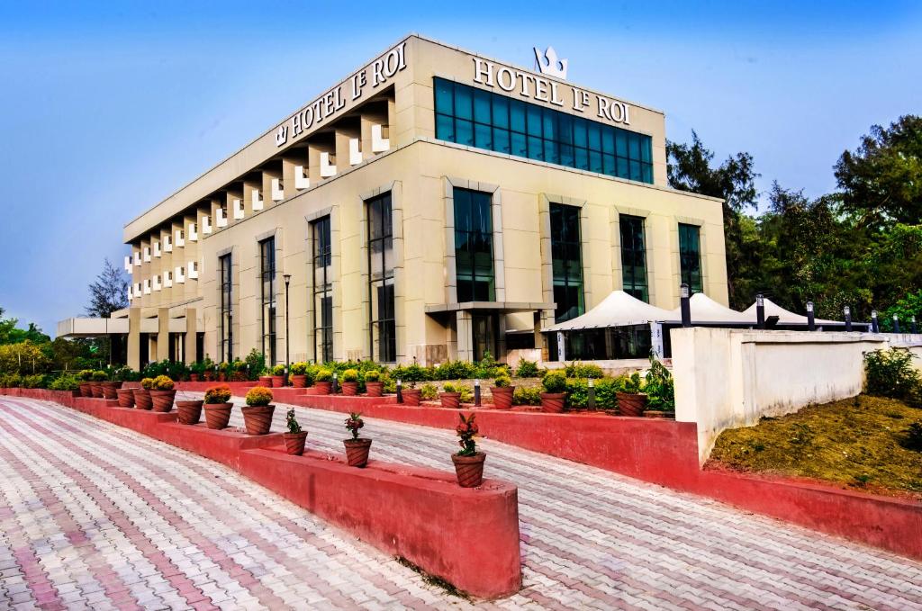 um edifício com vasos de plantas à sua frente em Le Roi Digha em Digha