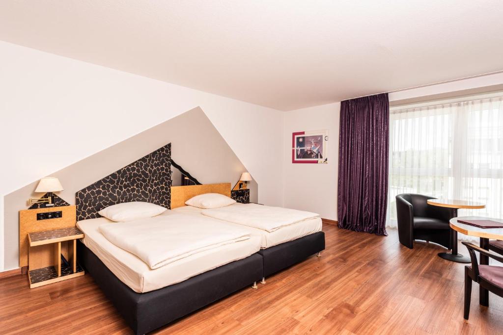 Postel nebo postele na pokoji v ubytování ARVENA Kongress Hotel - Hotel in der Wagnerstadt