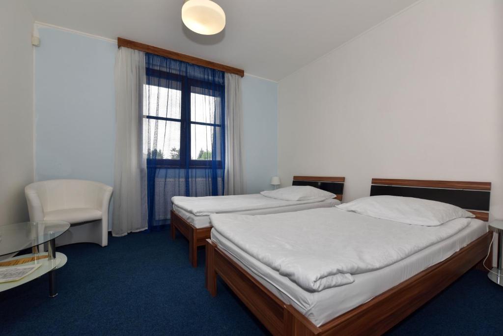Postel nebo postele na pokoji v ubytování Hotel Trilobit