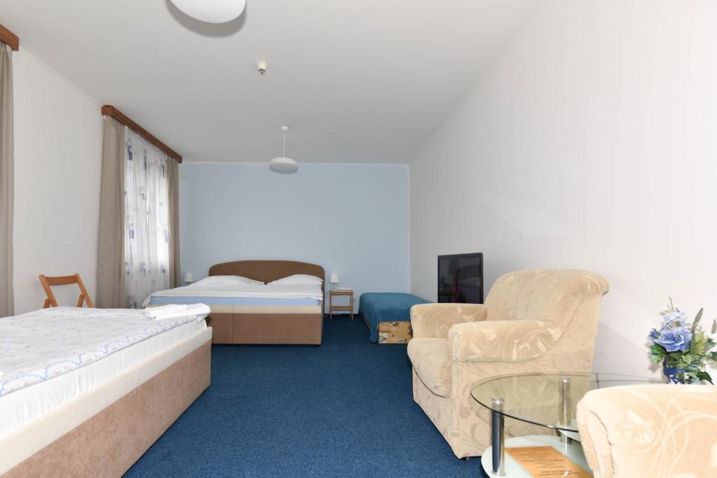 Postel nebo postele na pokoji v ubytování Hotel Trilobit