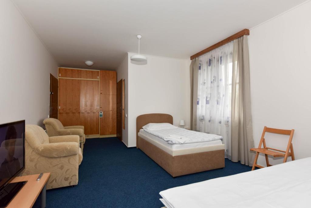 Postel nebo postele na pokoji v ubytování Hotel Trilobit