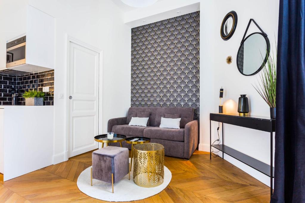 a living room with a couch and a table at CMG Trocadéro / Doumer in Paris