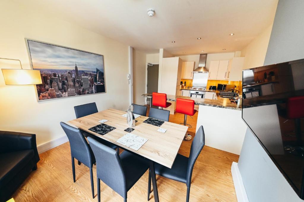 a kitchen and dining room with a table and chairs at The Stay Company, Derby Central in Derby