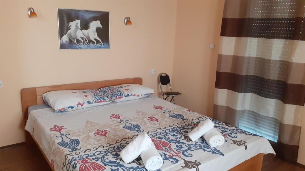 a small bedroom with a bed with towels on it at Sunshine in Gevgelija