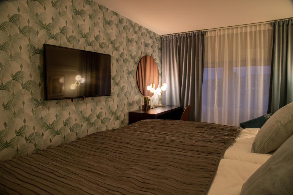 Postel nebo postele na pokoji v ubytování Hotell Syfabriken