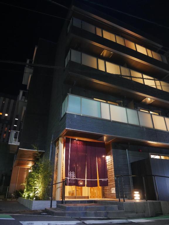 a building at night with its lights on at Apartment Hotel Tenjin TUMUGU in Fukuoka