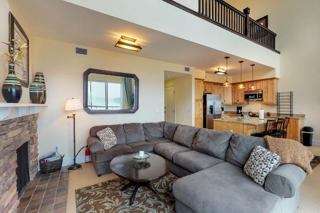 a living room with a couch and a fireplace at Seasons 331 - Penthouse in Sandpoint