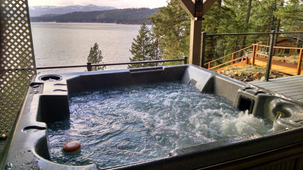 a hot tub on a deck with a view of a lake at Picture Perfect Panoramic Paradise in Twin Beaches