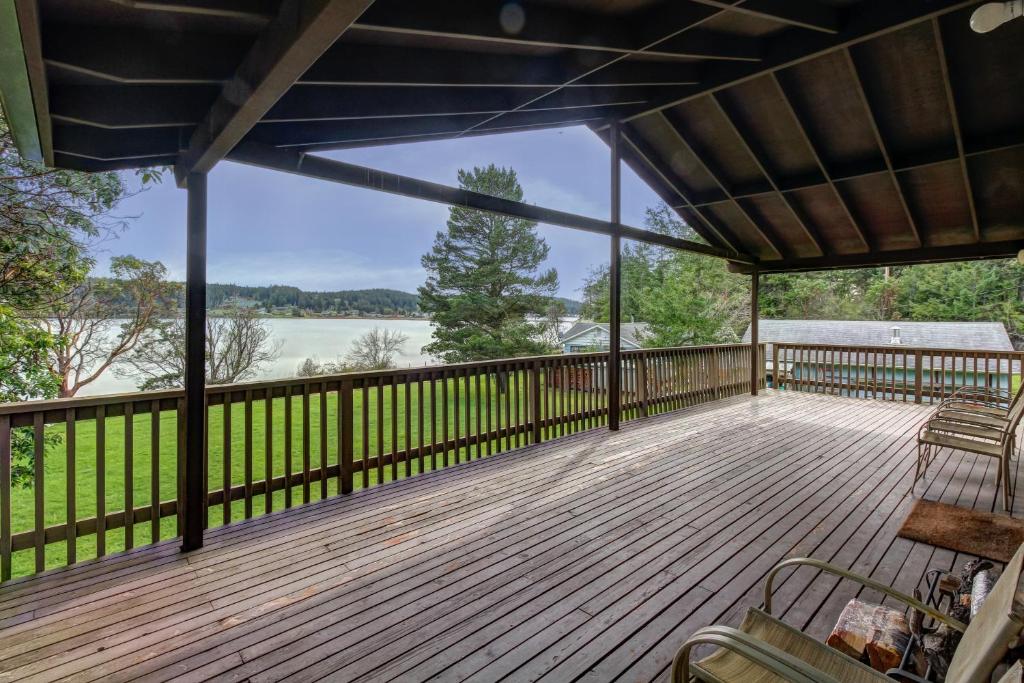 a large deck with a view of the water at Fisherman Bay Beach House in Lopez