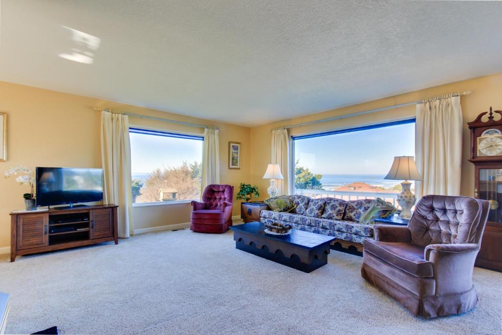 a living room with a couch and a tv at Ocean View Terrace in Lincoln City