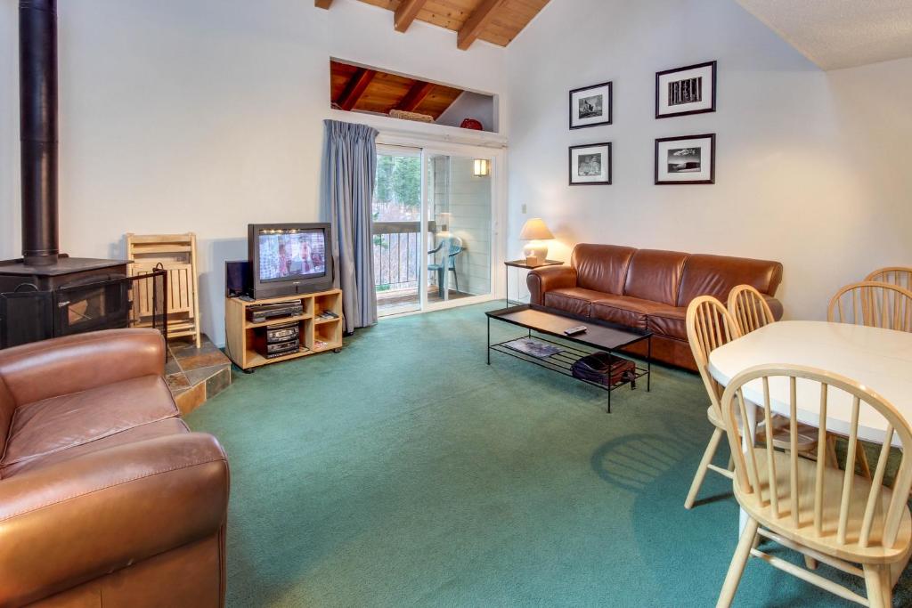 a living room with a couch and a television at Carnelian Woods Sanctuary in Carnelian Bay