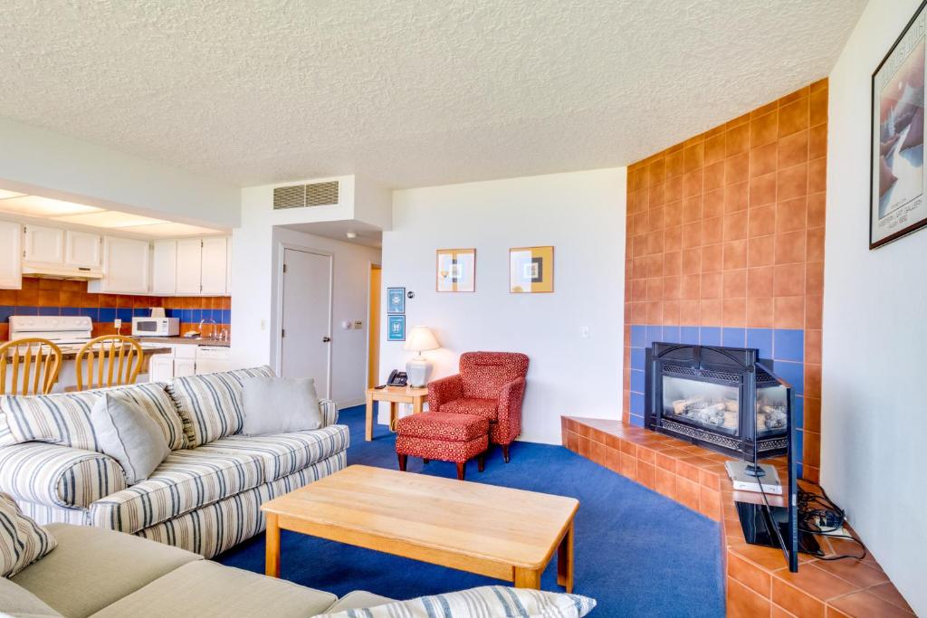 a living room with a couch and a fireplace at Sand & Sea: The Promenade (100) in Seaside