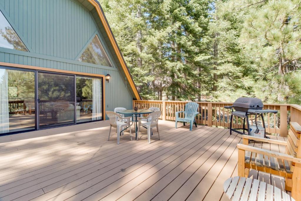 a deck with a table and chairs and a grill at Chamonix Chalet in Truckee