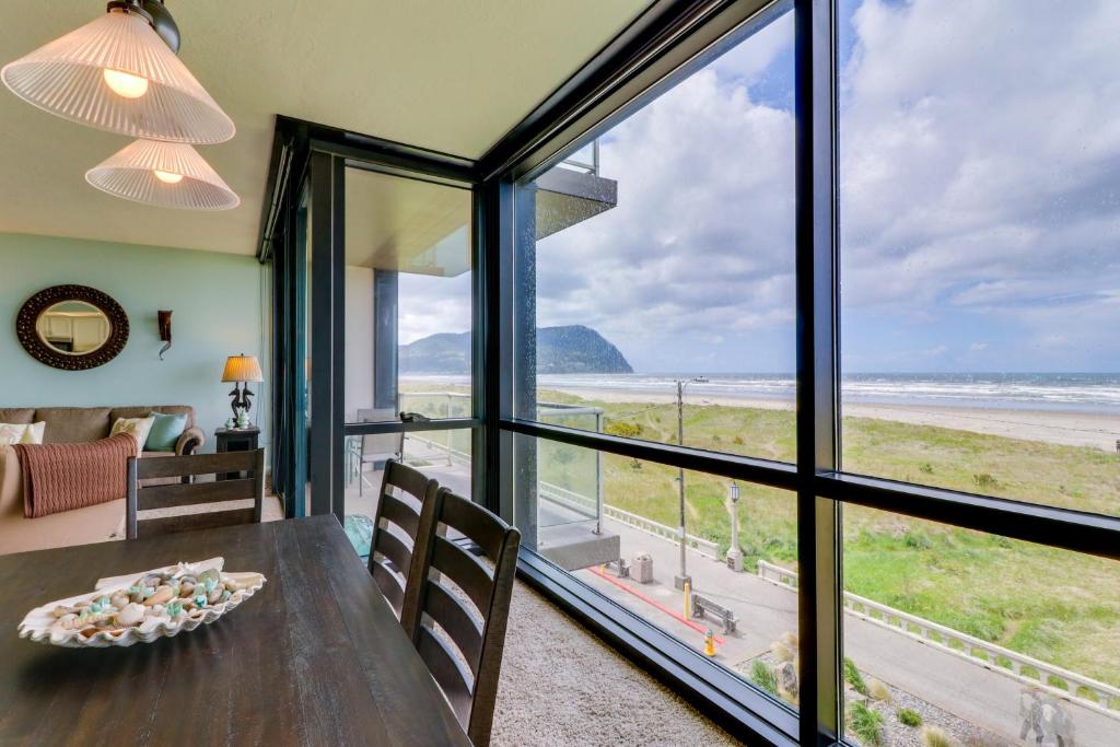 a dining room with a view of the ocean at Sand & Sea: Room 308 in Seaside