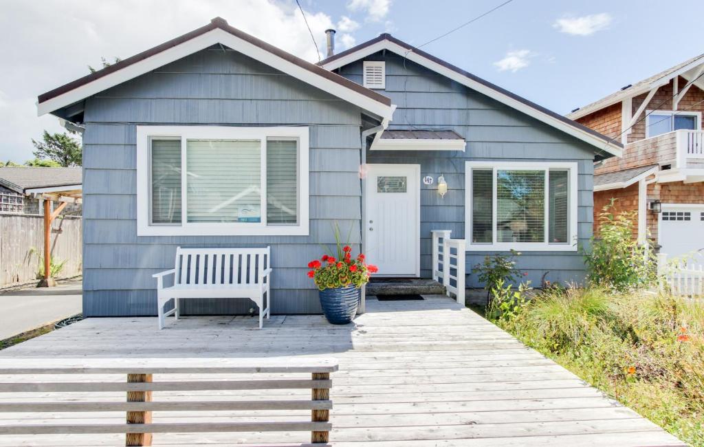 a blue house with a bench in front of it at La Bella Vita in Cannon Beach