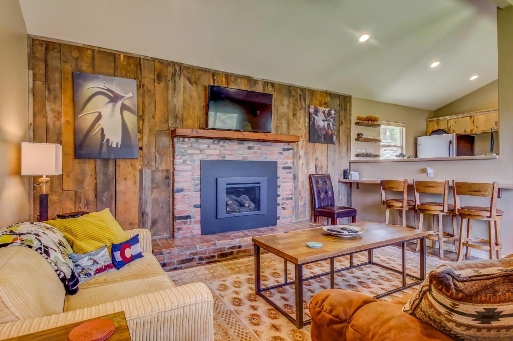 a living room with a fireplace and a couch at La Plata View in Durango