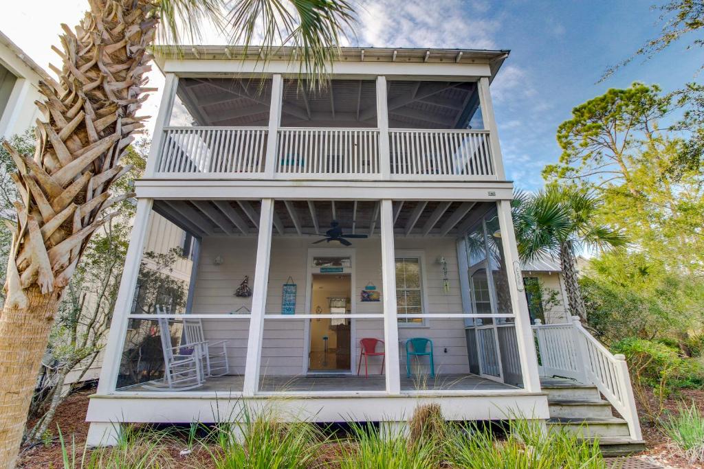a beach house with a wrap around porch at Barefoot Cottages #C56 in Highland View
