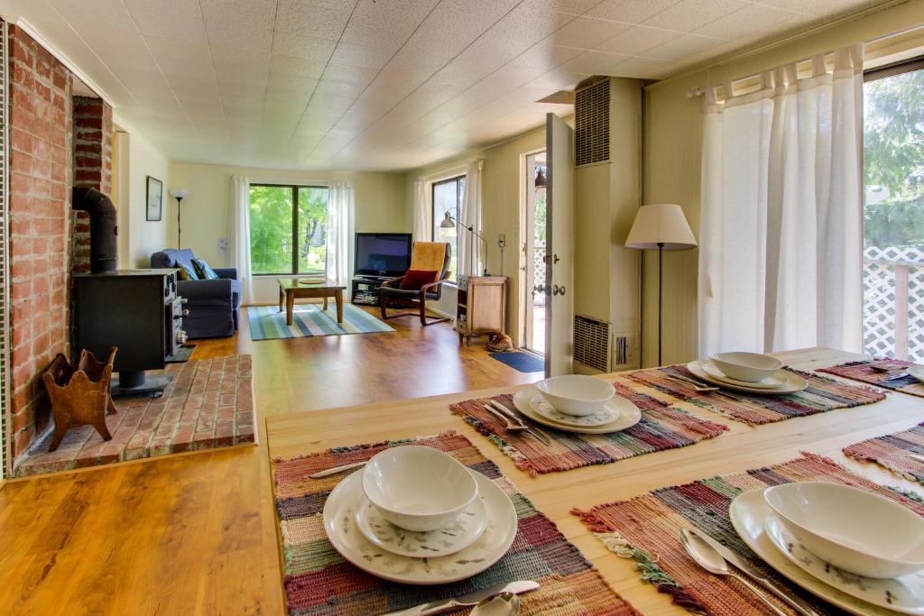 a living room with a table with plates on it at Ridge Path Cottage in Gearhart