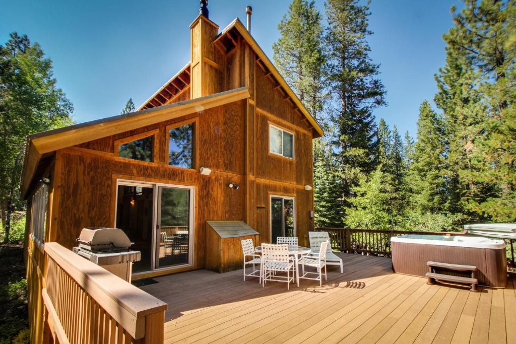 a house with a deck with a hot tub at Tahoe Donner Greenbelt Retreat in Truckee