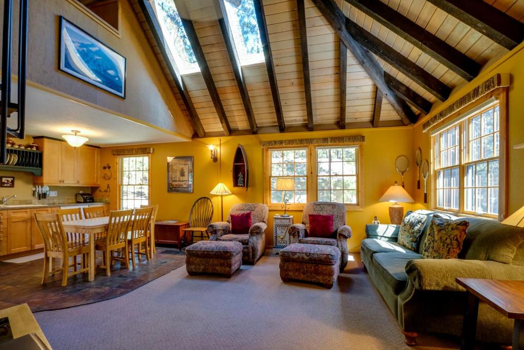 a living room with a couch and chairs and a kitchen at 1 Pine Mountain in Sunriver